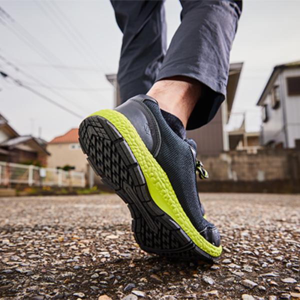 A person walking on the street wearing a pair of shoes.