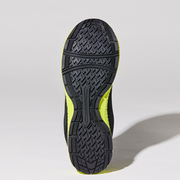 The image shows the sole of a black and yellow running shoe, providing traction and support for athletic activities.